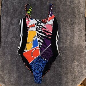 Women’s Adidas multi colored one piece bathing suit. Brand new with tags size 12